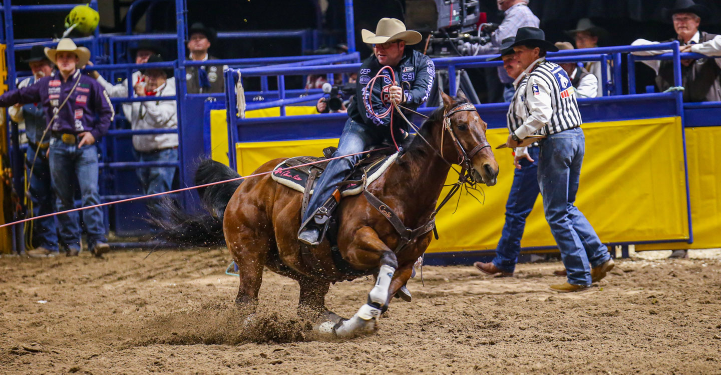 Coleman Proctor riding a brown horse in Las Vegas at the National Finals Rodeo. (NFR)